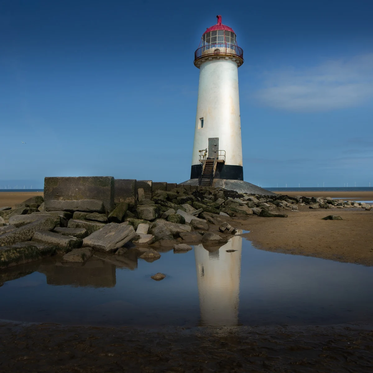 Lighthouse reflected in still water